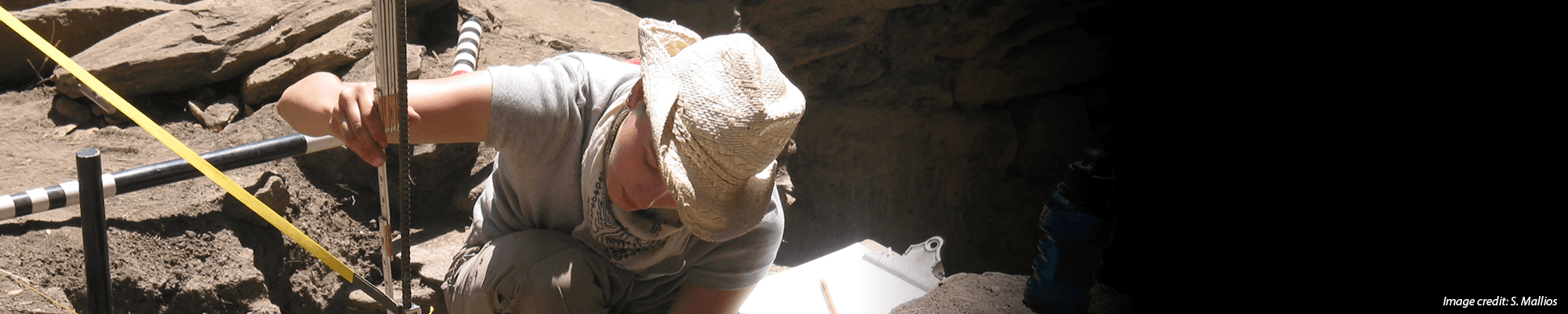 student works at archeological dig