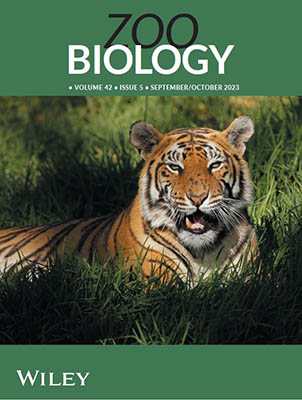 cover - tiger sits in grass, Zoo Biology