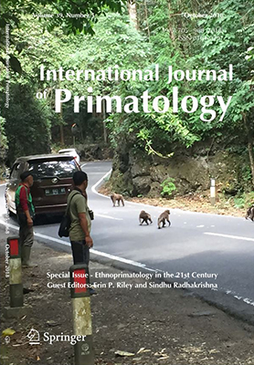 cover - people watch moneys cross road, International Jounral of Primatology