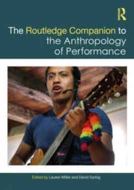 cover -person sings and plays guitar with rainbow ribbon on guitar neck