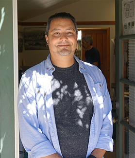 Isaac stands in doorway of La Mesa History center